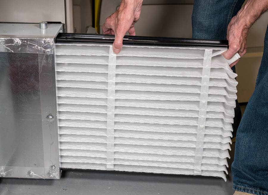 Man installing a new air conditioner filter